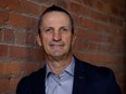 Guy Carbonneau stands against a brick wall