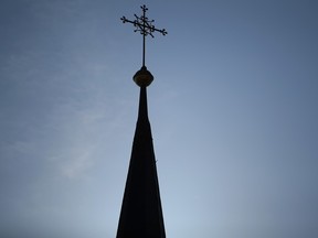 A cross stands on the spire of a Catholic church on September in this file photo.