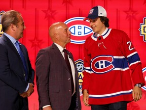 A young hockey player wears a Habs jersey on stage at the NHL Draft