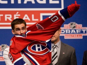 Louis Leblanc puts on a Canadiens jersey after being drafted