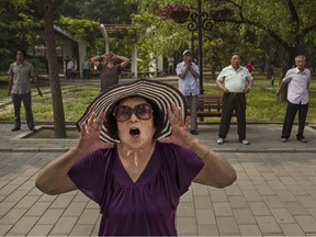 A woman shouts during morning exercises at Ritan Park on June 9, 2016, in Beijing. Coaches and sports psychologists have been harnessing the powers of self-talk since the late 1980s, when studies started revealing its role in improving athletic performance.