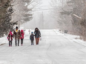 A family of five walk towards the Canada