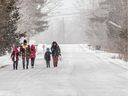 A family of five walk towards the Canada - USA border at Lacolle on Thursday February 23, 2023 in hopes of becoming Canadian refugees. Dave Sidaway / Montreal Gazette