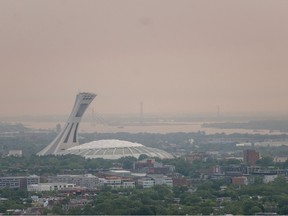 Aerial view of Montreal's Olympic Stadium shrouded in smog