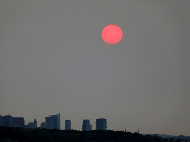 a red sun over the boston skyline