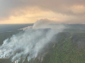 Photo of a billowing forest fire taken from a helicopter