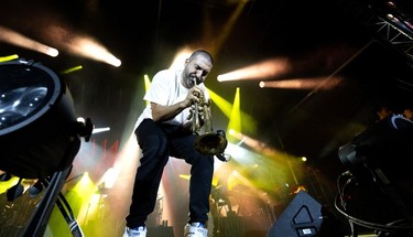 A man plays the trumpet on stage