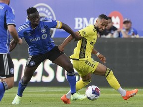 Nashville SC midfielder Hany Mukhtar, right and CF Montreal midfielder Victor Wanyama battle for the ball during first half MLS soccer action on Wednesday, June 21, 2023 in Montreal.