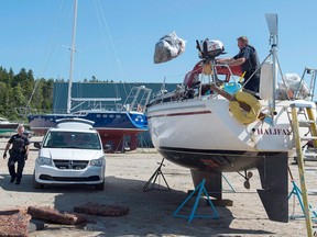 Canada Border Services Agency officers remove waterlogged material from the sailboat Quesera at East River Marine in Hubbards, N.S., on Sept. 8, 2017. About 250 kilograms of suspected cocaine were found on the vessel and two men were arrested.