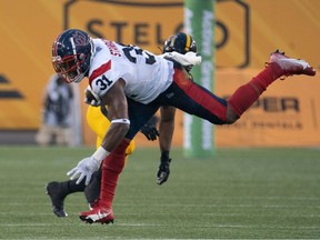 Alouettes running back William Stanback (31) runs for a gain against the Tiger Cats in Hamilton on Friday, June 23, 2023.