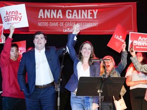 Anna Gainey has her arm raised on stage at her victory party