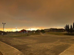 Smoke is seen obscuring the sky on the Ouje-Bougoumou Cree Nation, Que., in a June 6, 2023, handout photo. The First Nations community in northern Quebec was abruptly evacuated Tuesday as an out-of-control wildfire approached.