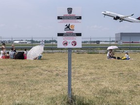 A sign warning people that the consumption of food is prohibited is shown at Jacques de Lesseps plane spotting park next to Trudeau Airport in Montreal, Sunday, June 11, 2023.