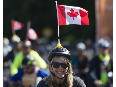 Flying the flag on Rosemont Blvd. during the 38th Tour de l'île de Montréal in Montreal on Sunday, June 4, 2023.