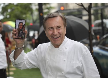 Ritz Carlton Chef Daniel Boulud shows family members the scene during a FaceTime call at the Grand Prix Party 2023 at the Ritz Carlton on Friday, June 16, 2023.