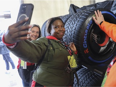 New York City resident Latrice Triplett takes a selfie with tires during an F1 Experiences tour of the paddock area at Circuit Gilles Villeneuve during a practice/qualifying session for the Canadian Grand Prix on Saturday, June 17, 2023 in Montreal.