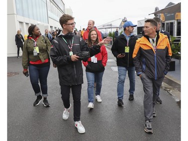 Dino Stermin (left with glasses) of F1 Experiences Expert Hosts gives clients a tour of the paddock area at Circuit Gilles Villeneuve during a practice/qualifying session for the Canadian Grand Prix on Saturday, June 17, 2023 in Montreal.