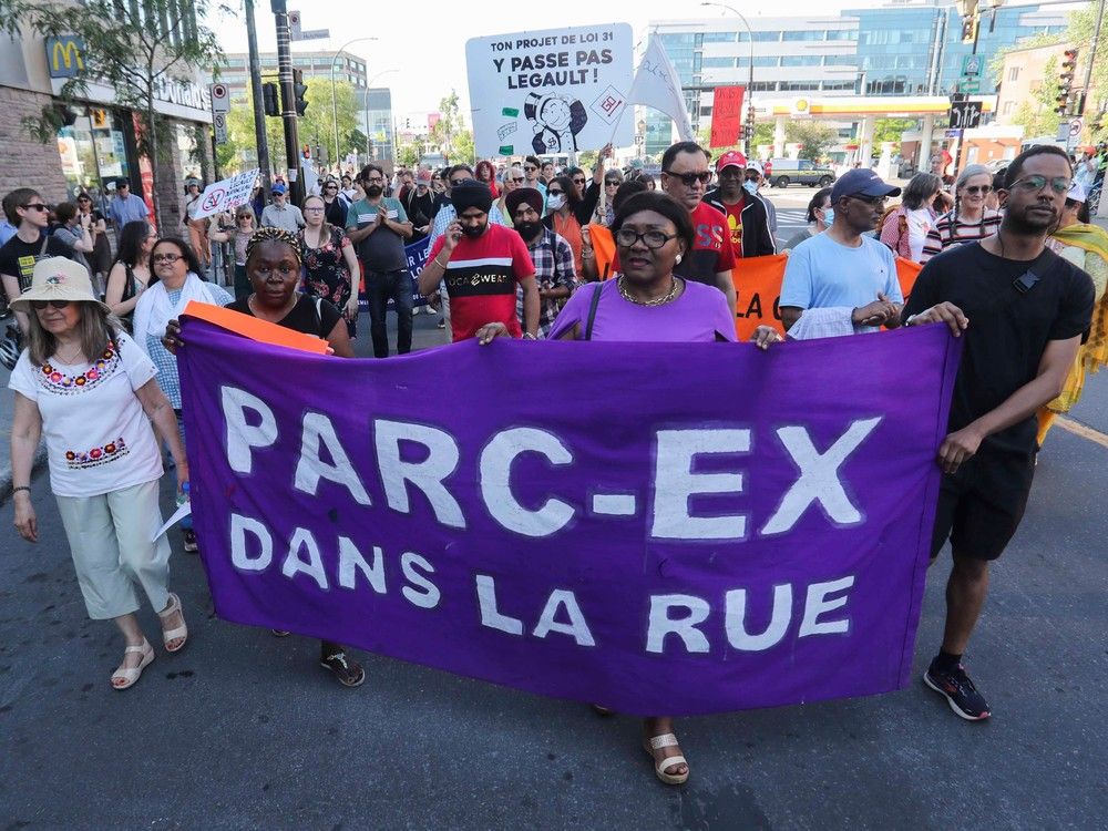 People march on Jean-Talon Street in Montreal Thursday, June 22, 2023. Housing groups took part in a march calling on the government to cancel a plan to ban lease transfers. The two housing groups are Comit&eacute; d'Action de Parc-Extension (CAPE) and the Regroupement des comit&eacute;s logement et associations de locataires du Qu&eacute;bec (RCLALQ).