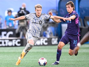 CF Montréal midfielder Bryce Duke, left, and Charlotte FC midfielder Benjamin Bender (15) fight for the ball during the first half of an MLS soccer match on Saturday, June 24, 2023, in Charlotte, N.C.