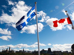 Canadian Flag and Quebec Flag are seen over looking the Ottawa River from the Civilization Museum behind Parliament Hill in Gatineau Sept 19, 2012.