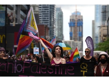 Participants walk in the Dyke Parade, on Saturday, June 24, 2023, as part of Pride Celebrations in Toronto.