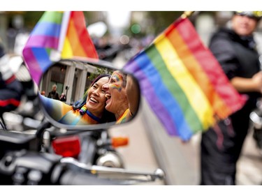 Jennifer Kanenaga, left, and AnMarie Rodgers prepare to kick-off San Francisco's Pride Parade as part of the Dykes on Bikes contingent on Sunday, June 25, 2023.