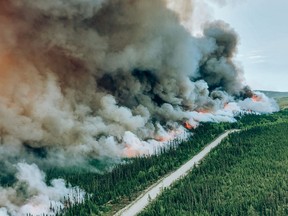 A controlled burn is seen on the edge of a wildfire numbered 334 near Mistissini, Que., in a June 6, 2023, handout photo. A Cree community in northern Quebec is evacuating this morning, due to heavy smoke from a nearby forest fire.