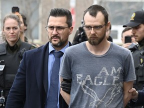 Steeve Gagnon is escorted by police out of court in Amqui, Que., Tuesday, March 14, 2023. Gagnon, a Quebec man accused of deliberately driving his truck into pedestrians in March, will have a preliminary hearing in September.