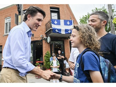 Prime Minister Justin Trudeau greets a young boy during an event on Saint-Jean-Baptiste in Montreal on Saturday, June 24, 2023.