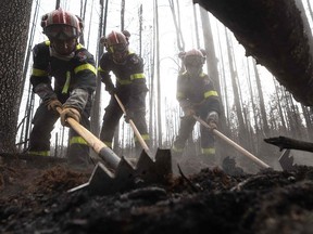 Firefighters from France help battle fires in Quebec in June 2023. Several miners had to stop operations as Canada grappled with one of the worst starts to its wildfire season.
