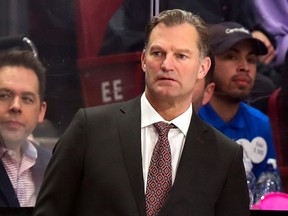 Kirk Muller in a suit looking worried behind the bench