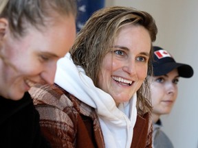 Marie-Philip Poulin at a news conference with two fellow players