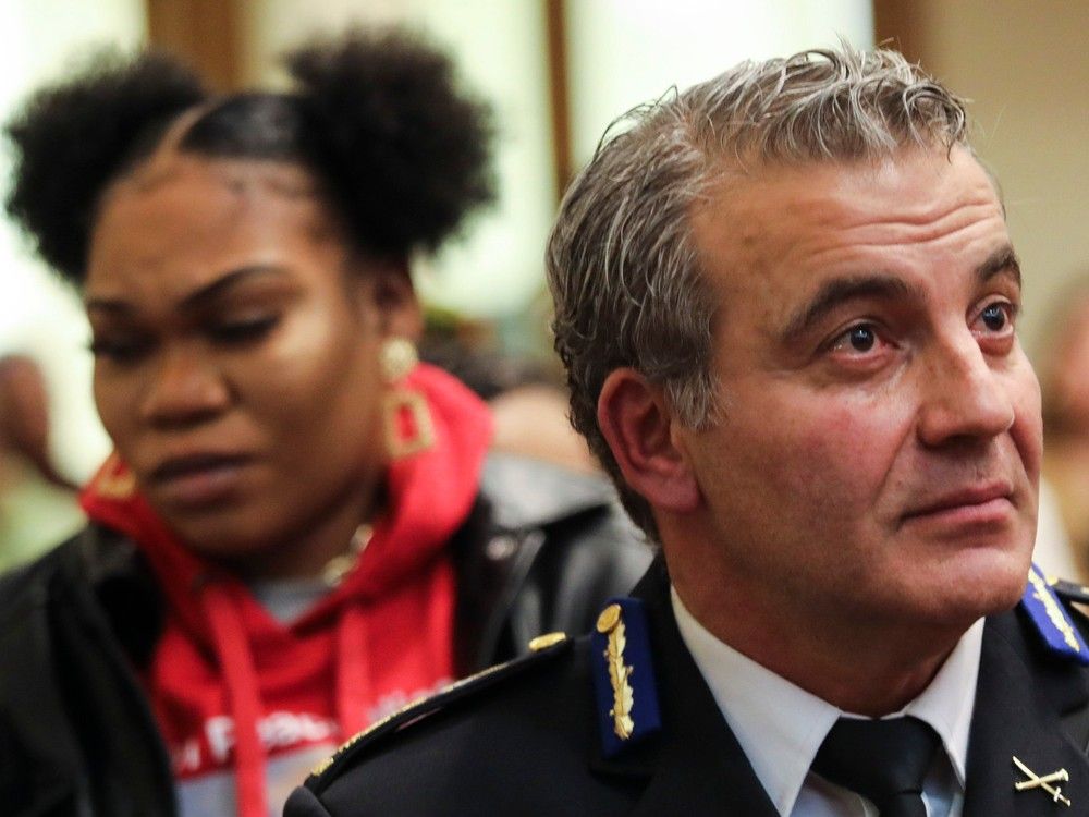 Montreal police Chief Fady Dagher is seen at an event for crime victims in March. Behind is Sarafina Dennie, the sister of Nicous D'Andre Spring, who died while illegally detained at Bordeaux jail in 2022.