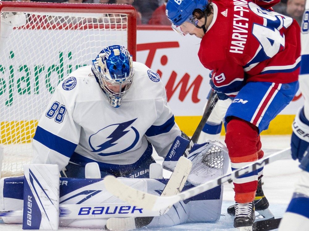 Tampa Bay Lightning goalie Andrei Vasilevskiy makes save on the Canadiens’ Rafaël Harvey-Pinard during game at the Bell Centre in Montreal on March 21, 2023.