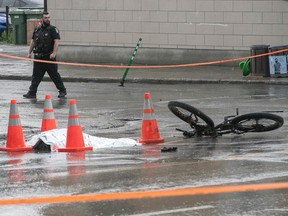 a mangled bike is part of a crime scene after a fatal collision