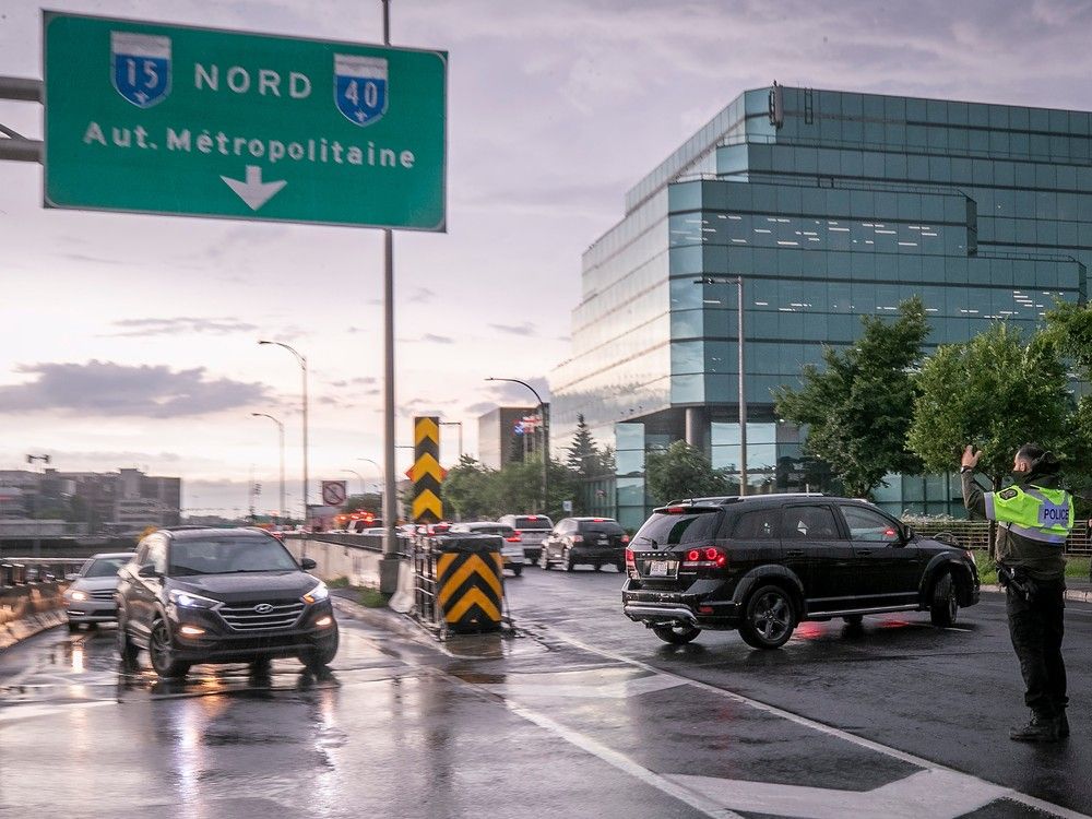 Vehicles emerge from an on-ramp and make a U-turn on Décarie Blvd.