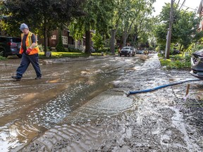 a city worker walks on a flooded street