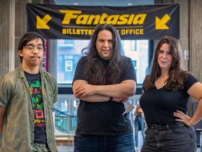 Three people in front of a Fantasia banner