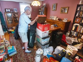 a man packs boxes of belongings