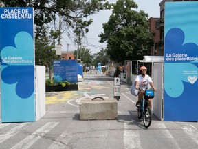 a person cycles through signs at the edge of de castelnau street