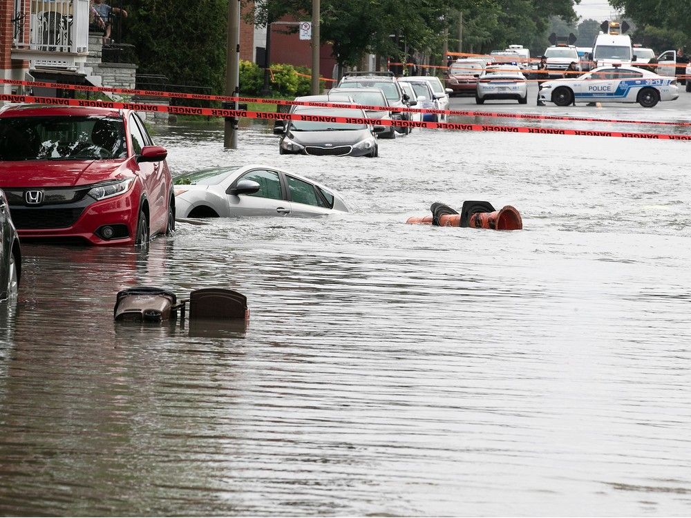 a montreal street and cars are submerged after a water main break