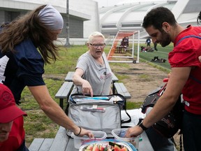 Heather Lowengren yells out to Alouettes players, Marc-Antoine Dequoy, left, and punter Joseph Zema.