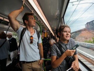 Éric and his father, André, look out from an REM train as it approaches Central Station in Montreal from the South Shore on Saturday July, 29, 2023.