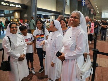 Sisters of the Compassionnistes Servites de Marie, from the right, sister Paola Vengaroth, sister Geraldine Jumawid and sister Vineetha Puthenparambilan wait in line for an REM train at Central Station in Montreal on Saturday July, 29, 2023.
