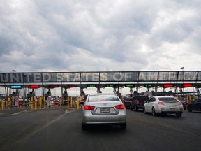 Cars wait in line at a border crossing into the United States
