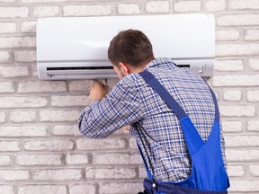 A technician repairing an air conditioner
