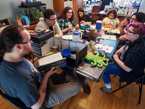 a family plays dungeons and dragons at the dining room table
