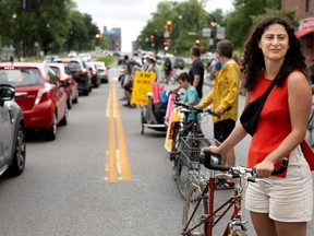 Camielle Saade-Traboulsi joins other bike activists on a human bike path on Parc Ave. in Montreal, on Saturday, July 22, 2023.
