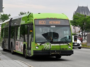 A Quebec City transit bus is seen with the Château Frontenac in the background