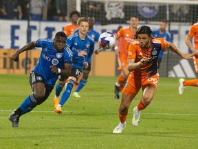 CF Montréal's Sunusi Ibrahim, left, races New York City FC's Justin Haak to get the ball during first half MLS action in Montreal on Saturday, July 1, 2023.
